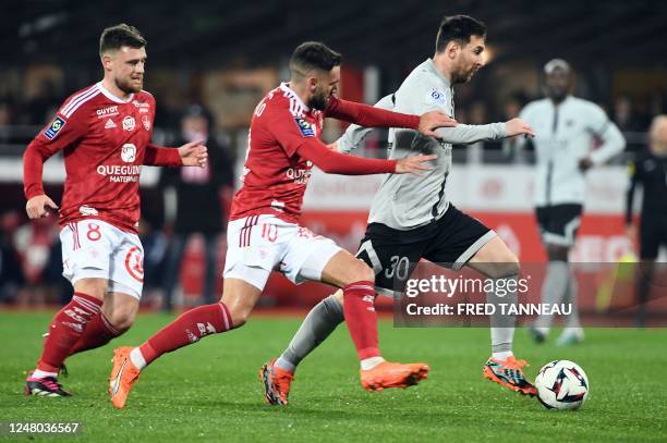 Brest's French midfielder Romain Del Castillo fights for the ball with Paris Saint-Germain's Argentine forward Lionel Messi during the French L1...