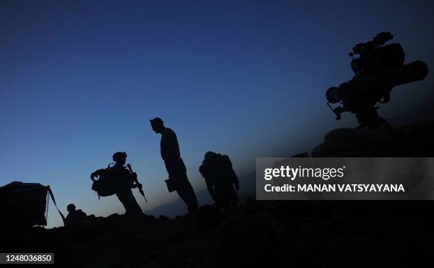 Soldiers from the 1st Platoon Alpha 3-71 cavalry prepare to walk downhill from an outpost in the Baraki Barak district of Logar Province on August...