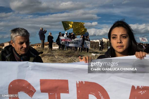 People end a protest march on the beach at the site of the shipwreck on March 11, 2023 in Steccato di Cutro, Calabria region, southern Italy, as part...