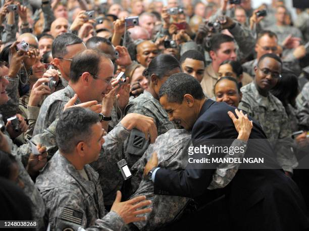 President Barack Obama greets troops during a visit to Camp Victory, just outside Baghdad, on April 7, 2009. - US President Barack Obama planned to...