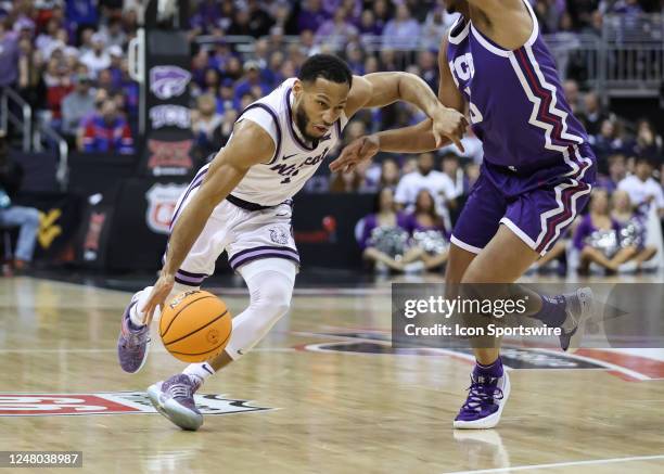 Kansas State Wildcats guard Markquis Nowell gets low to drive to the basket in the first half of a Big 12 Tournament quarterfinal basketball game...