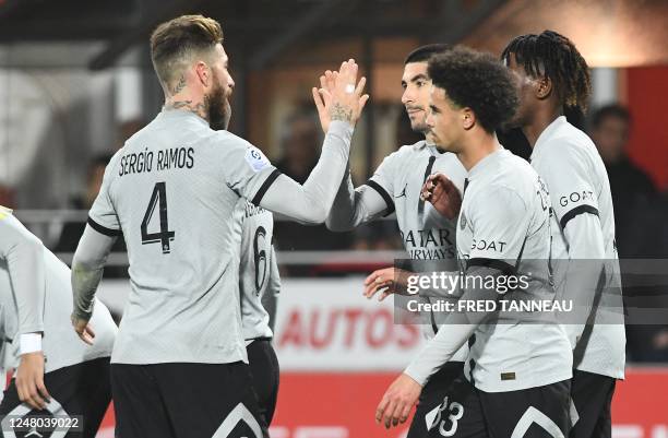 Paris Saint-Germain's Spanish midfielder Carlos Soler is congratulated by Paris Saint-Germain's Spanish defender Sergio Ramos after scoring a goal...