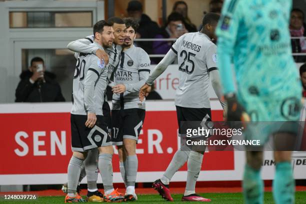 Paris Saint-Germain's French forward Kylian Mbappe is congralulated by Paris Saint-Germain's Argentine forward Lionel Messi after scoring a goal...