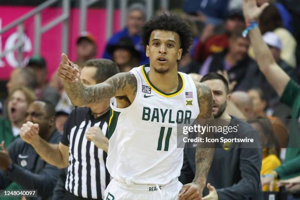 Baylor Bears forward Jalen Bridges points to celebrate making a three in the second half of a Big 12 Tournament quarterfinal basketball game between...