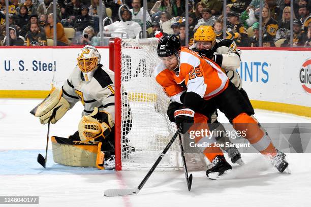 James van Riemsdyk of the Philadelphia Flyers skates against Dmitry Kulikov of the Pittsburgh Penguins at PPG PAINTS Arena on March 11, 2023 in...