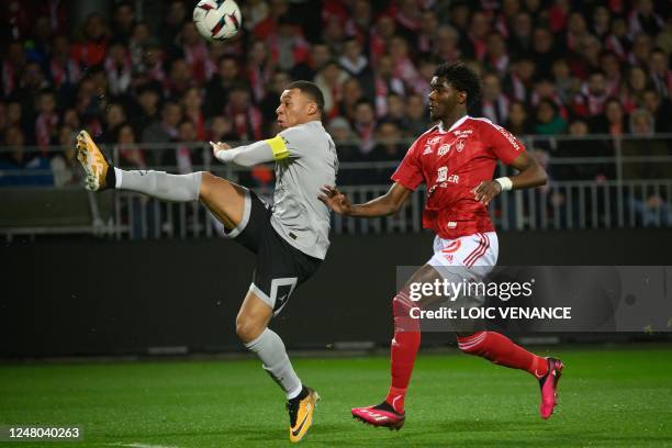 Paris Saint-Germain's French forward Kylian Mbappe kicks the ball during the French L1 football match between Stade Brestois 29 and Paris...