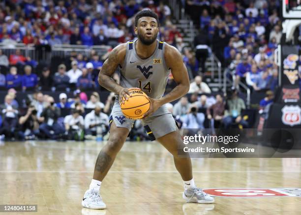 West Virginia Mountaineers guard Seth Wilson looks to pass in the second half of a Big 12 Tournament quarterfinal basketball game between the West...