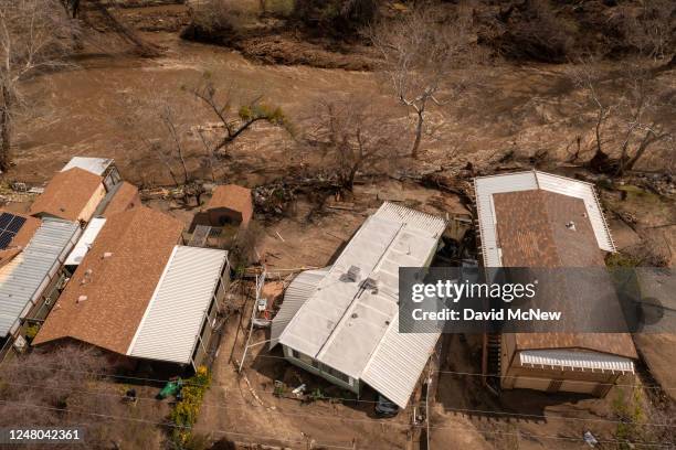 In an aerial view, damaged homes and property that were hit by a flash flood on the Tule River are seen on March 10, 2023 in Springville, California....