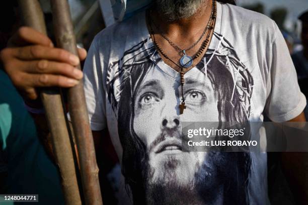 Faithful wearing a t-shirt with an image of Jesus Christ marches towards the Basilica of Lujan on March 11 in Lujan, Buenos Aires province, to...