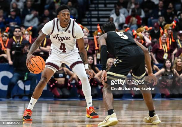 Texas A&M Aggies guard Wade Taylor IV moves the ball on Vanderbilt Commodores guard Ezra Manjon during an SEC Mens Basketball Tournament game between...