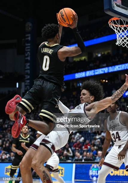 Vanderbilt Commodores guard Tyrin Lawrence drives to the basket and fouls Texas A&M Aggies forward Andersson Garcia during an SEC Mens Basketball...