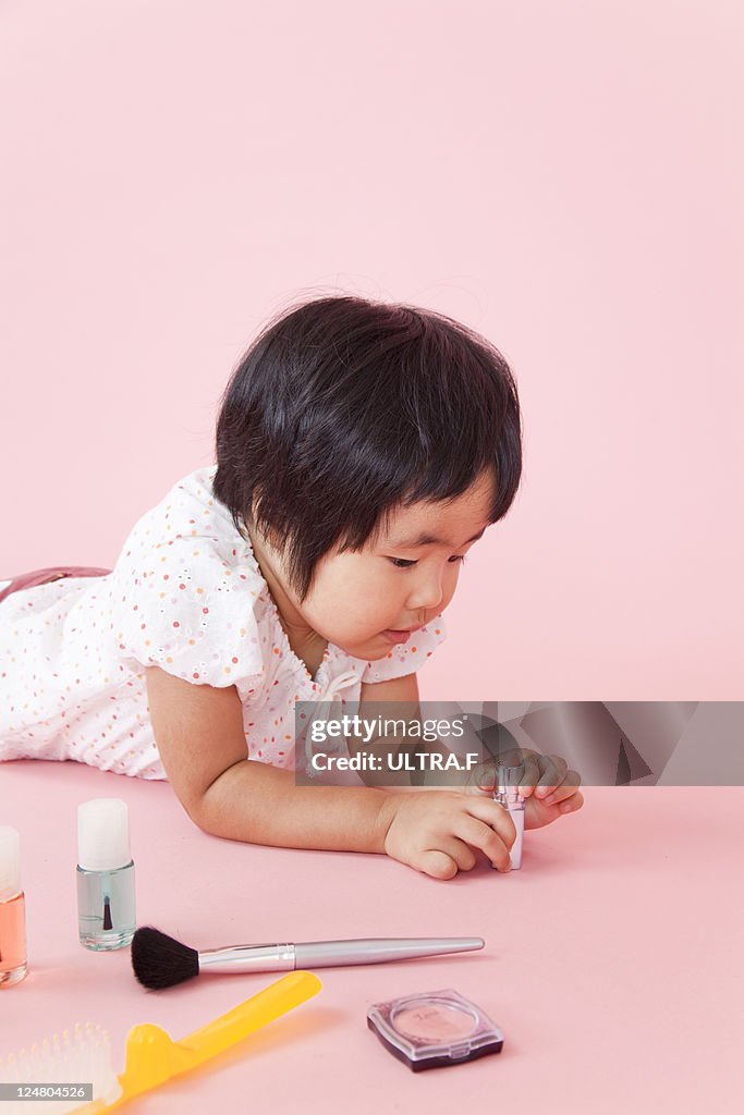 Japanese girl is playing to cosmetics.