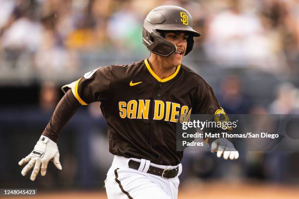 Ethan Salas of the San Diego Padres sprints to first base during a spring training game against the Chicago White Sox on March 11, 2023 in Peoria,...