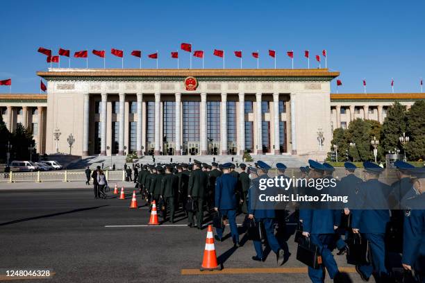 Deputies to the 14th National People's Congress walk to the Great Hall of the People for the fifth plenary meeting of the first session of the 14th...