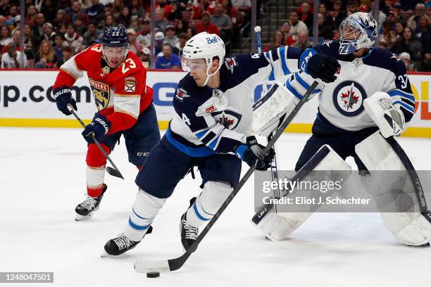 Neal Pionk of the Winnipeg Jets skates with the puck against the Florida Panthers at the FLA Live Arena on March 11, 2023 in Sunrise, Florida.
