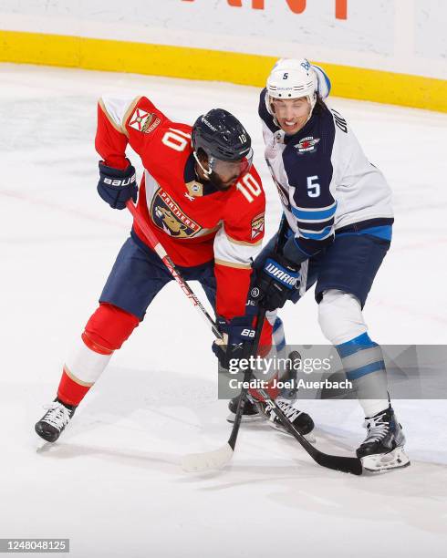 Anthony Duclair of the Florida Panthers and Brenden Dillon of the Winnipeg Jets battle for position in front of the net during second period action...