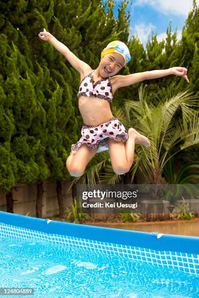 family photograph - young girl jumping into swimming pool stock pictures, royalty-free photos & images