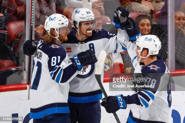 Mark Scheifele celebrates his overtime game winning goal with Kyle Connor and Nate Schmidt of the Winnipeg Jets against the Florida Panthers at the...