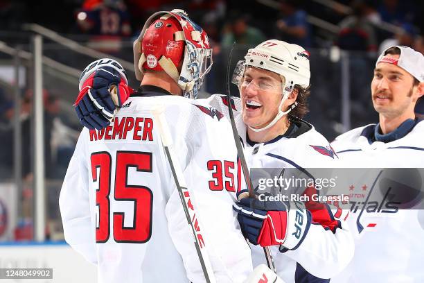 Darcy Kuemper and T.J. Oshie of the Washington Capitals celebrate the 5-1 win against the New York Islanders at UBS Arena on March 11, 2023 in...