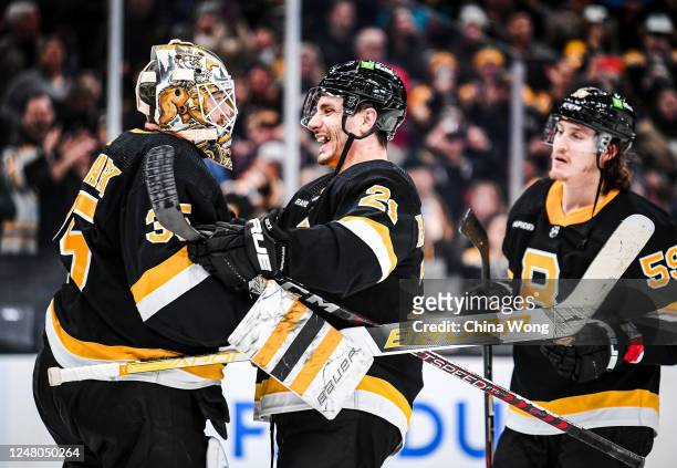 Garnet Hathaway of the Boston Bruins celebrates a win against the Detroit Red Wings with Linus Ullmark at TD Garden on March 11, 2023 in Boston,...