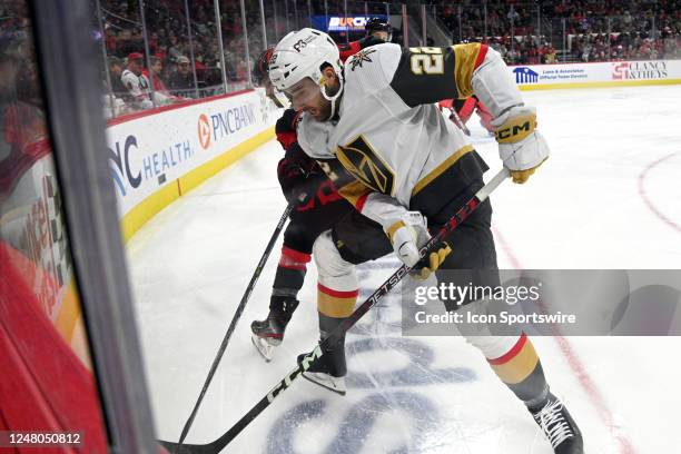 Carolina Hurricanes Defenceman Brett Pesce and Vegas Golden Knights Winger Michael Amadio battle for the puck along the board during the game between...