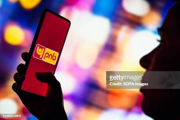 In this photo illustration, the Punjab National Bank logo seen displayed on a smartphone.