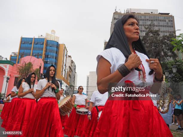 Women activists dressed in red and white performing as hundreds of women took to the streets to march asking for their rights, in the framework of...