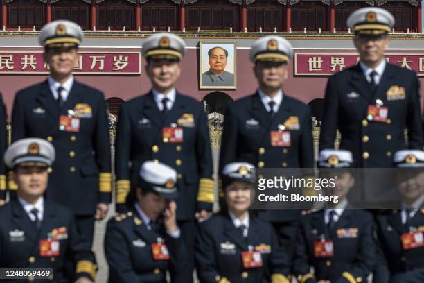 Military delegates have their photo taken after attending the fifth plenary session of the First Session of the 14th National People's Congress at...