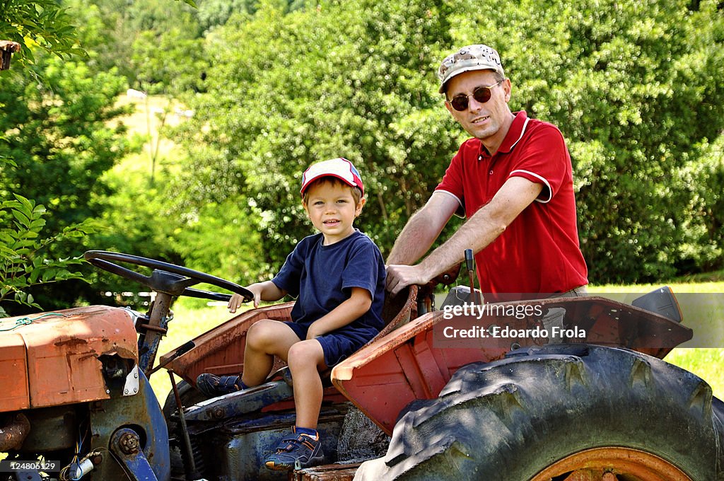 Father and son on tractor