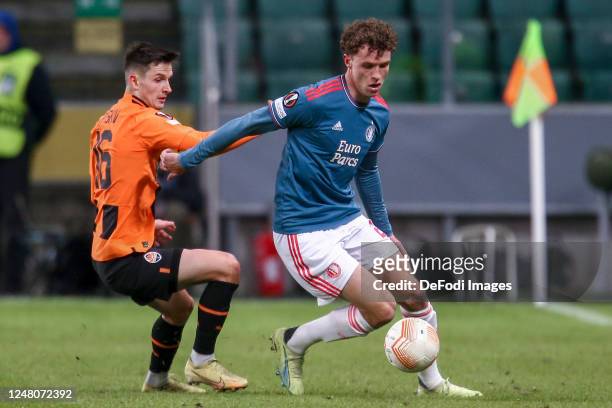 Dmytro Kryskiv of FC Shakhtar Donetsk and Mats Wieffer of Feyenoord Rotterdam Battle for the ball during the UEFA Europa League round of 16 leg one...