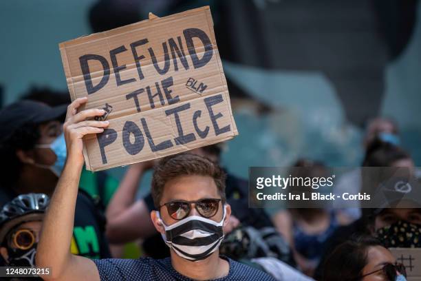 Protester in Times Square holds up a handmade sign that reads, "Defund The Police". This was part of the Black Lives Matter New York protest that...