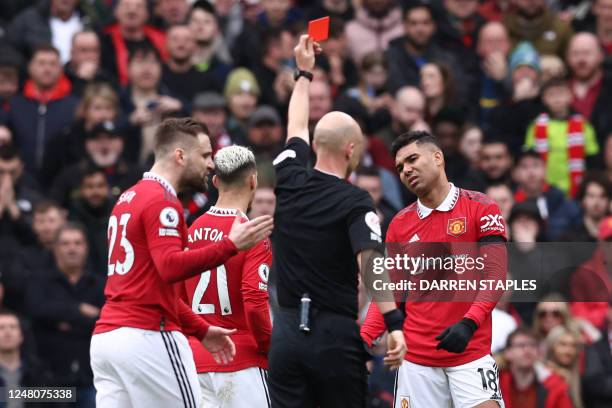 Manchester United's Brazilian midfielder Casemiro reacts after being shown a red card by English referee Anthony Taylor during the English Premier...