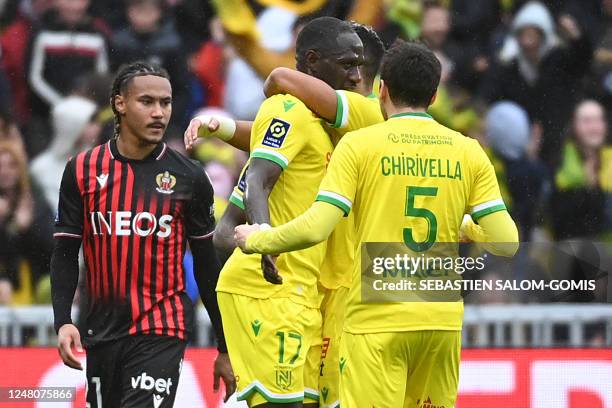 Nantes' French midfielder Moussa Sissoko is congratulated by teammates after he scored a first goal for his team during the French L1 football match...