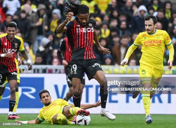 Nantes' French midfielder Ludovic Blas fights for the ball with Nices French midfielder Khephren Thuram during the French L1 football match between...