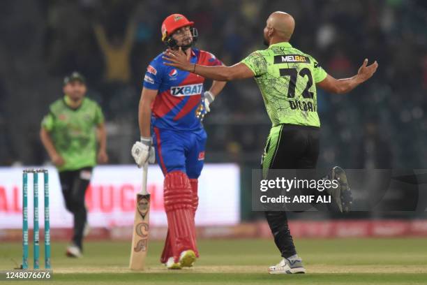 Lahore Qalandars' Dilbar Hussain celebrates the dismissal of Karachi Kings' Haider Ali during the Pakistan Super League Twenty20 cricket match...