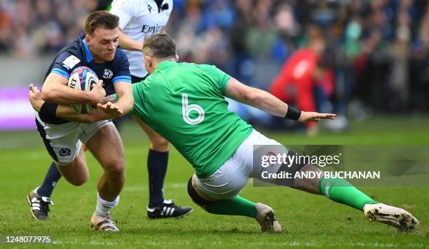 Ireland's flanker Peter O'Mahony tackles Scotland's fly-half Ben White during the Six Nations international rugby union match between Scotland and...