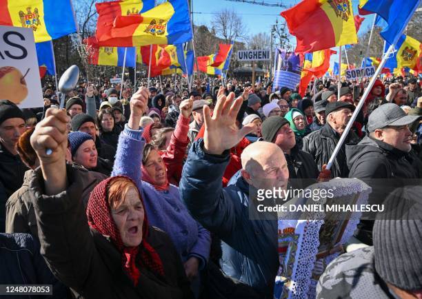 Moldovan demonstrators put their hands in the air and hold Moldova national flags during a protest organized by a Moldovan member of parliament on...