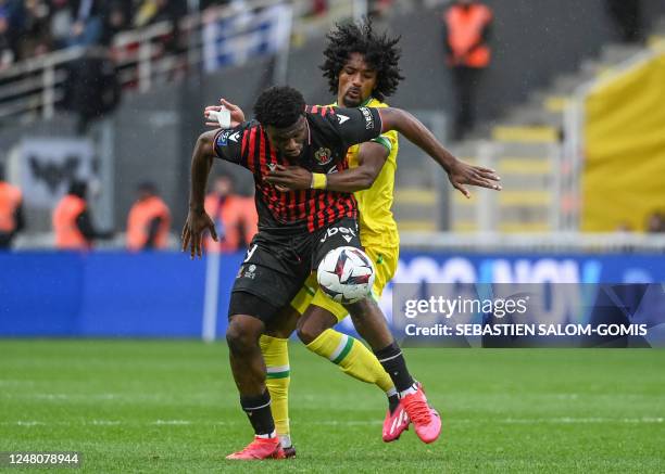 Nices Nigerian forward Terem Moffi fights for the ball with Nantes' French midfielder Samuel Moutoussamy during the French L1 football match between...