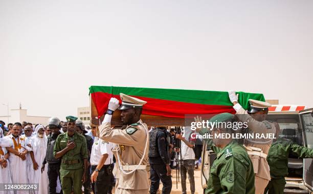 Pallbearers carry at the Ibn Abbas Mosque in Nouakchott, on March 12, 2023 the coffin of Mauritanian police officer Mustapha Ould El Khadir Ould...
