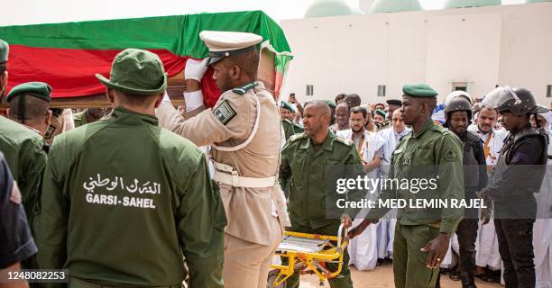 Pallbearers carry at the Ibn Abbas Mosque in Nouakchott, on March 12, 2023 the coffin of Mauritanian police officer Mustapha Ould El Khadir Ould...