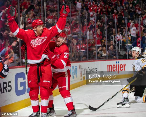 Alex Chiasson of the Detroit Red Wings celebrates his goal against the Boston Bruins with teammate Lucas Raymond during the first period of an NHL...