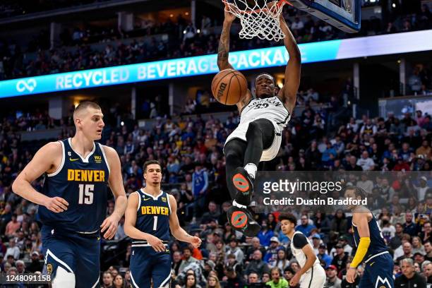 Nic Claxton of the Brooklyn Nets scores against the Denver Nuggets in the first half of a game against the Denver Nuggets at Ball Arena on March 12,...