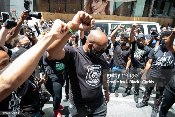 Hawk Newsome, Chairperson of BLMNY holds a circle with his team with their arms raised up with a fist just before addressing the thousands of...