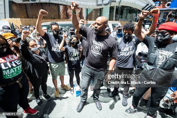 Hawk Newsome, Chairperson of BLMNY holds a circle with his team with their arms raised up with a fist just before addressing the thousands of...