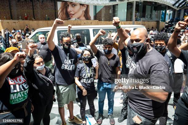 Hawk Newsome, Chairperson of BLMNY holds a circle with his team with their arms raised up with a fist just before addressing the thousands of...