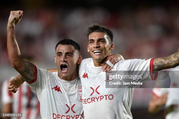 Juan Garro of Huracan celebrates with teammate Fernando Torrent after scoring the team's first goal during a match between Estudiantes and Huracan as...