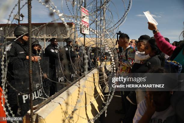 Migrants, mostly of Venezuelan origin, attempt to forcibly cross into the United States at the Paso del Norte International Bridge in Ciudad Juarez,...