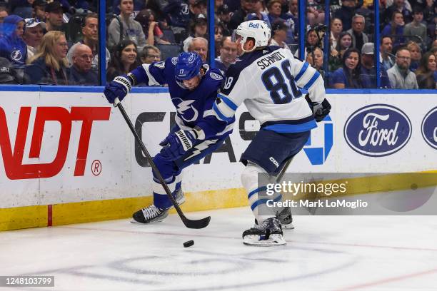 Alex Killorn of the Tampa Bay Lightning against Nate Schmidt of the Winnipeg Jets during the second period at Amalie Arena on March 12, 2023 in...