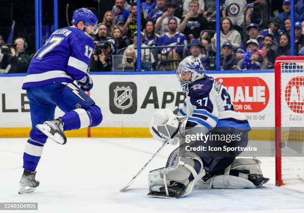 Tampa Bay Lightning left wing Alex Killorn jumps as Winnipeg Jets goaltender Connor Hellebuyck makes the save during the NHL Hockey match between the...