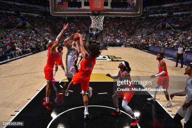 Jaylin Williams of the Oklahoma City Thunder blocks the shot attempt by Zach Collins of the San Antonio Spurs during the game on March 12, 2023 at...